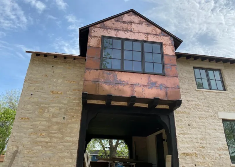Copper metal panel facade on a stone building for Roof Repair in Oildale