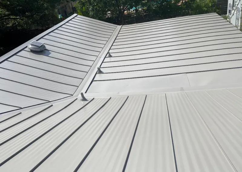 Solar attic fan installed on a metal roof for Roof Ventilation in Oildale